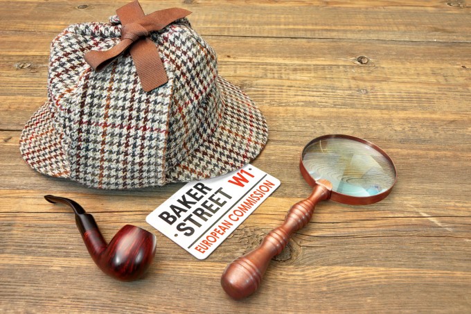 Baker Street Signboard, Sherlock Holmes Cap famous as Deerstalker, Smoking Pipe and Vintage Magnifier on Grunge Wood Table