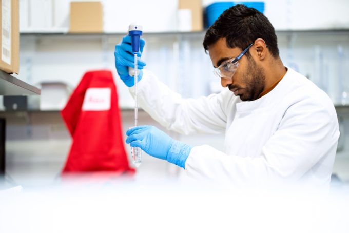 scientist in lab analysing chemicals